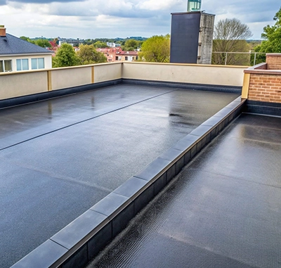 Flat EPDM roofing on a building with brick and concrete details.