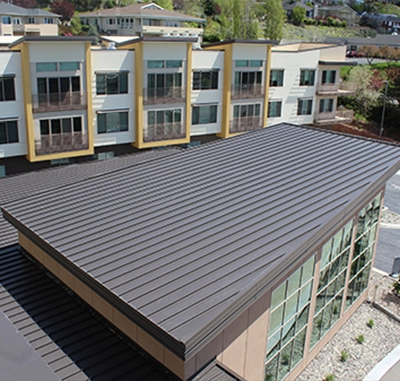 Flat, low-slope roofing on a modern building with large windows.