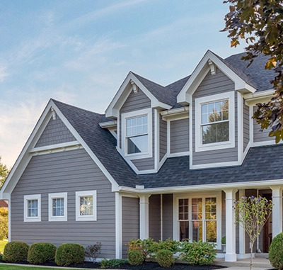 Two-story house with gray fiber cement siding and white trim.